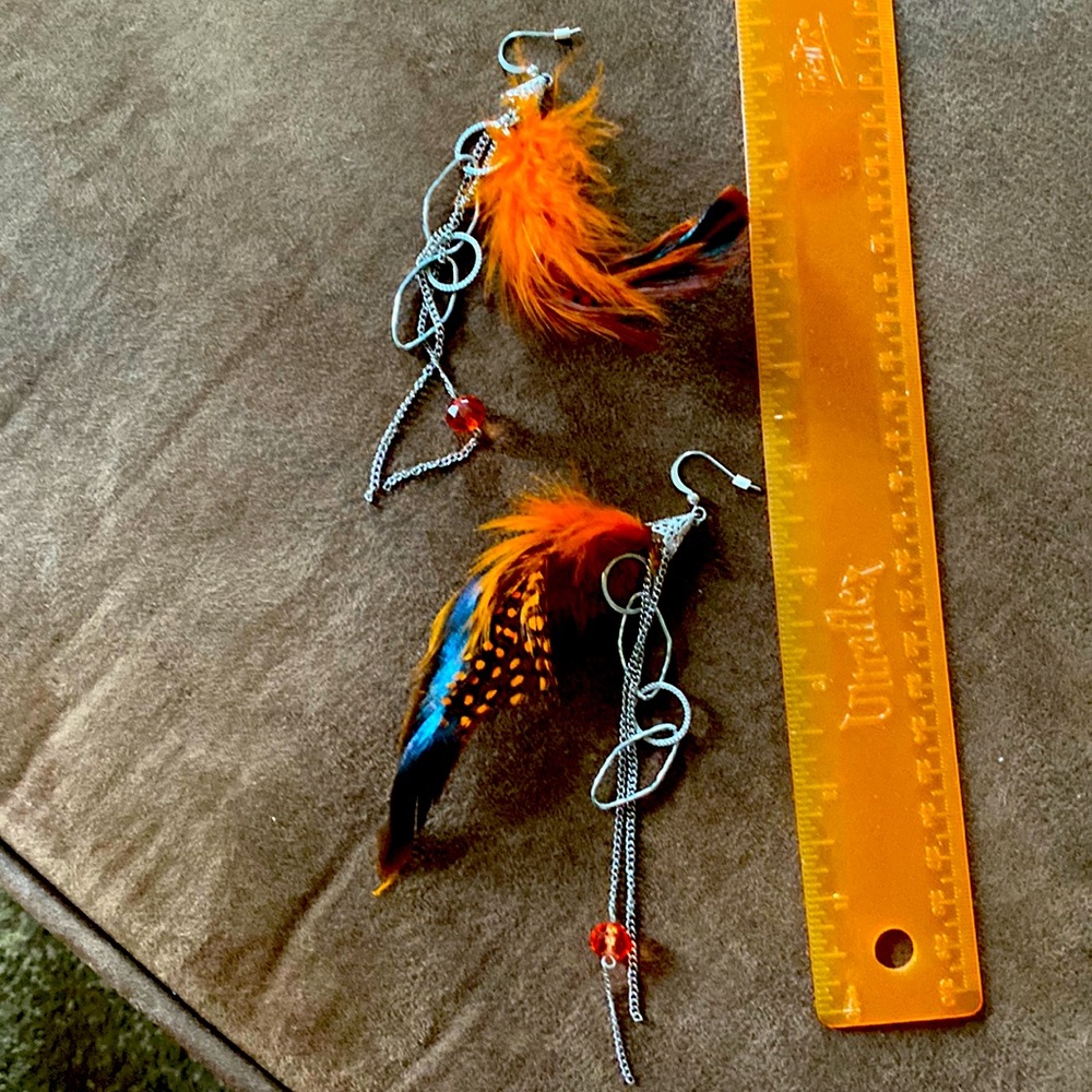Orange and silver feather earrings.
